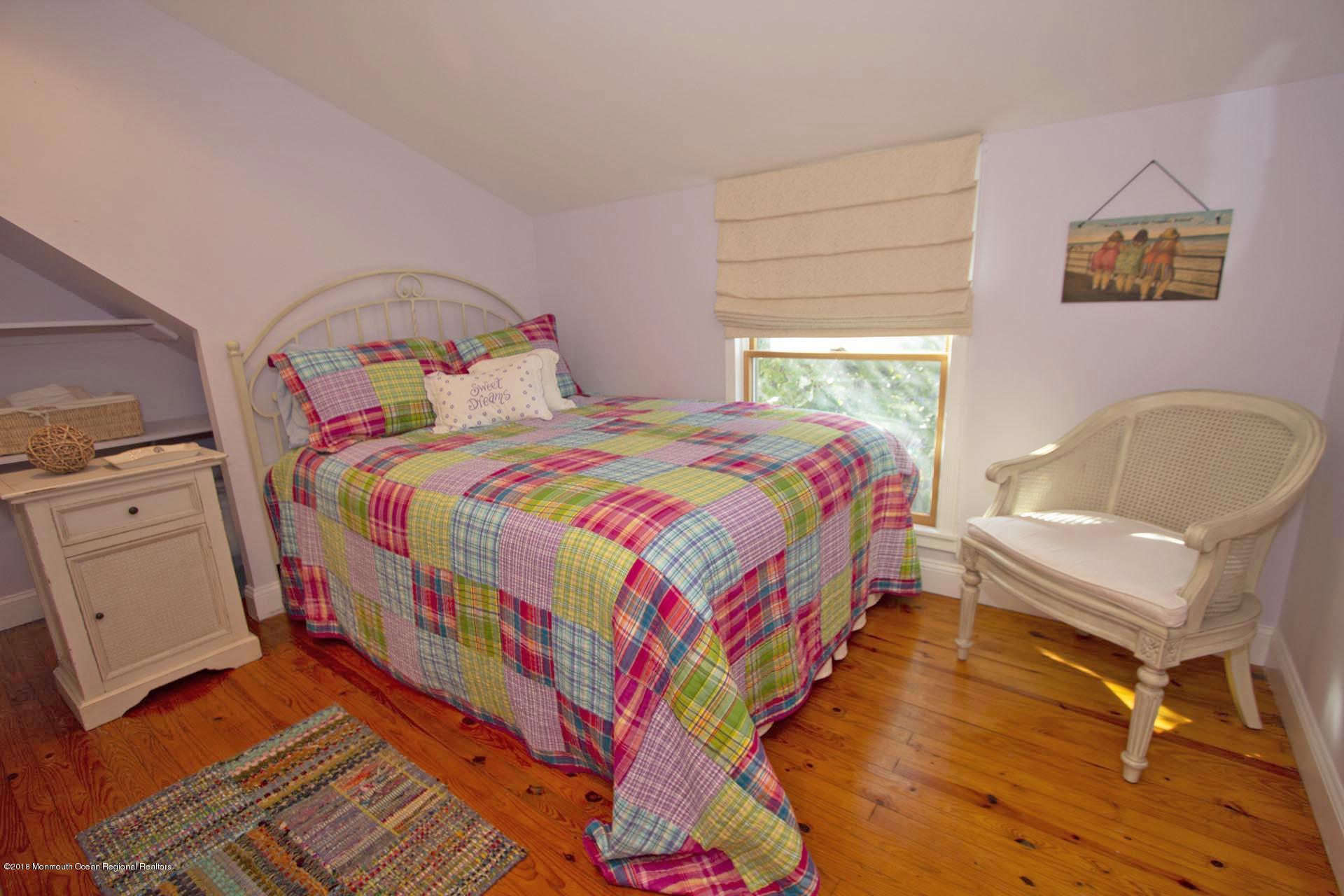 52 Fishermans Road Lavallette, NJ 08735 - Photo 42 of 74 a bedroom with a bed and wooden floor