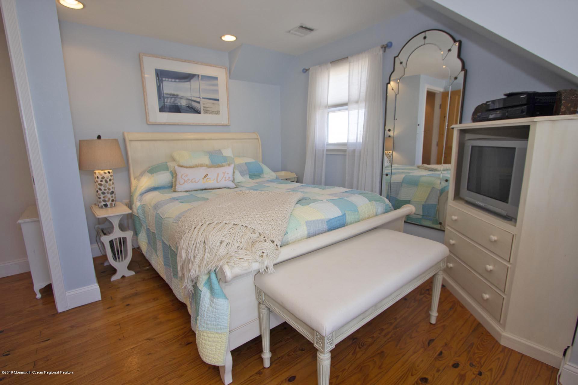 52 Fishermans Road Lavallette, NJ 08735 - Photo 48 of 74 a living room with a bed furniture and a flat screen tv