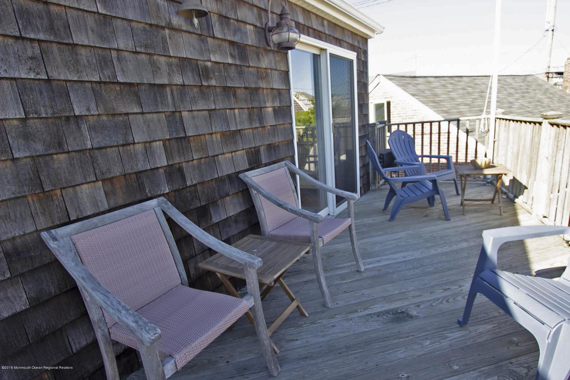 52 Fishermans Road Lavallette, NJ 08735 - Photo 52 of 74 an outdoor sitting area with couch and wooden floor