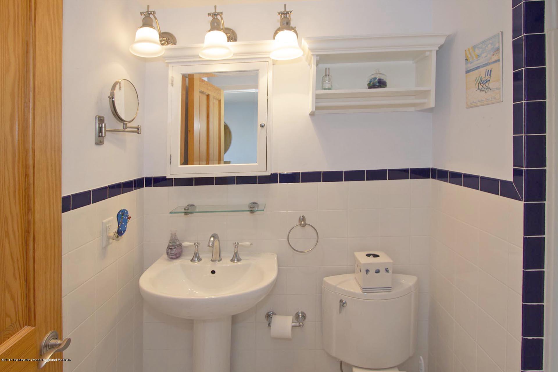 52 Fishermans Road Lavallette, NJ 08735 - Photo 53 of 74 a bathroom with a sink and a mirror