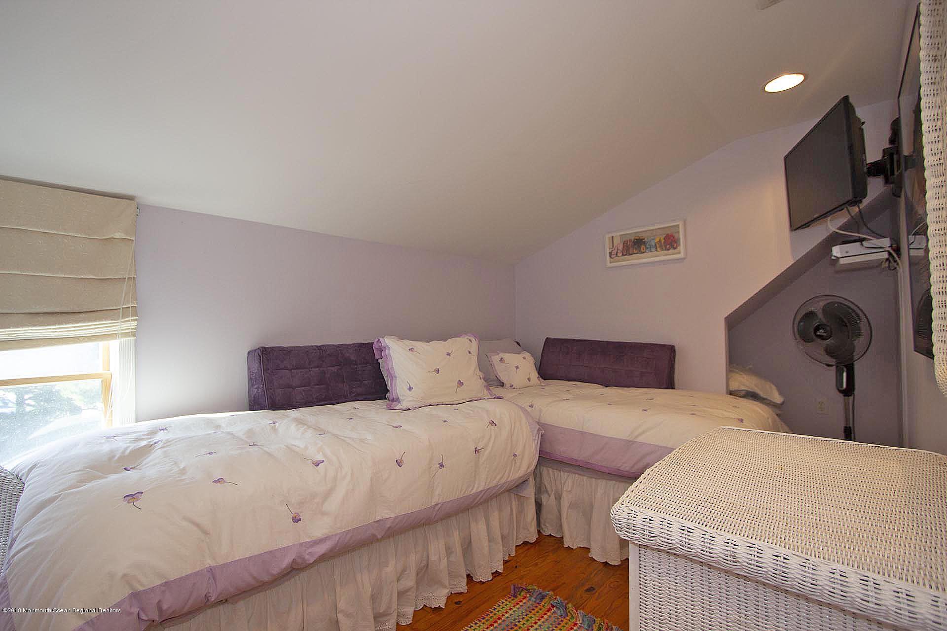 52 Fishermans Road Lavallette, NJ 08735 - Photo 55 of 74 a bedroom with a large bed and a flat tv screen on dresser