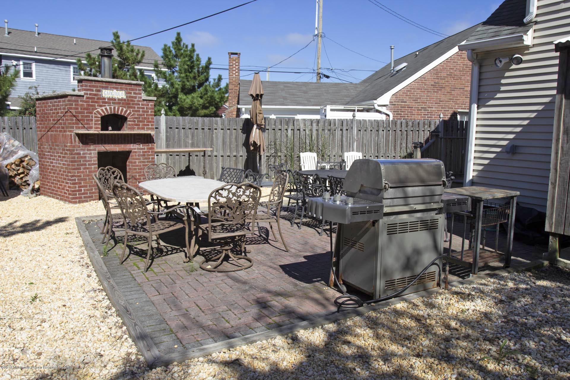52 Fishermans Road Lavallette, NJ 08735 - Photo 61 of 74 a view of a patio with table and chairs potted plants