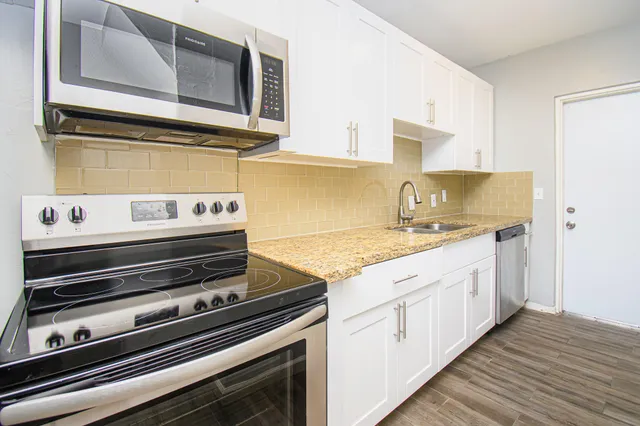 a kitchen with a stove and a microwave