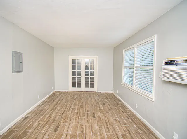 a view of a room with wooden floor and windows