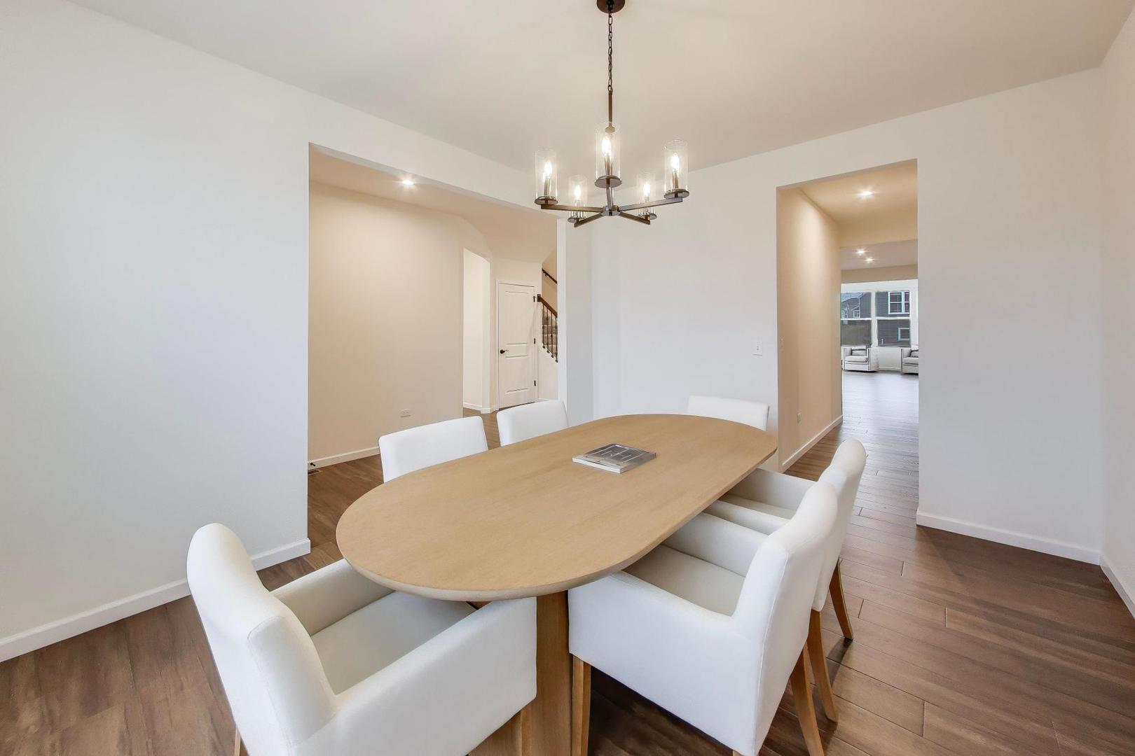 3744 Peregrine Way Elgin, IL 60124 - Photo 12 of 33 a view of a dining room with furniture and wooden floor
