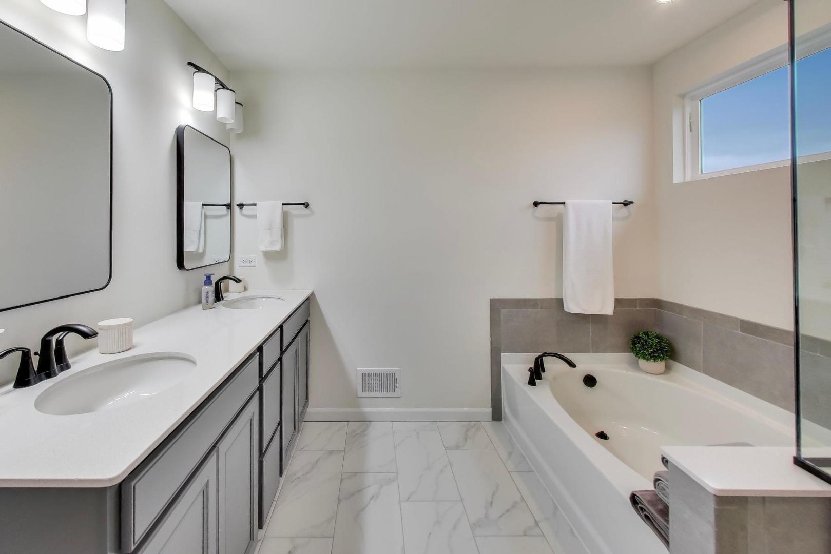 3744 Peregrine Way Elgin, IL 60124 - Photo 14 of 33 a bathroom with a tub sink and mirror