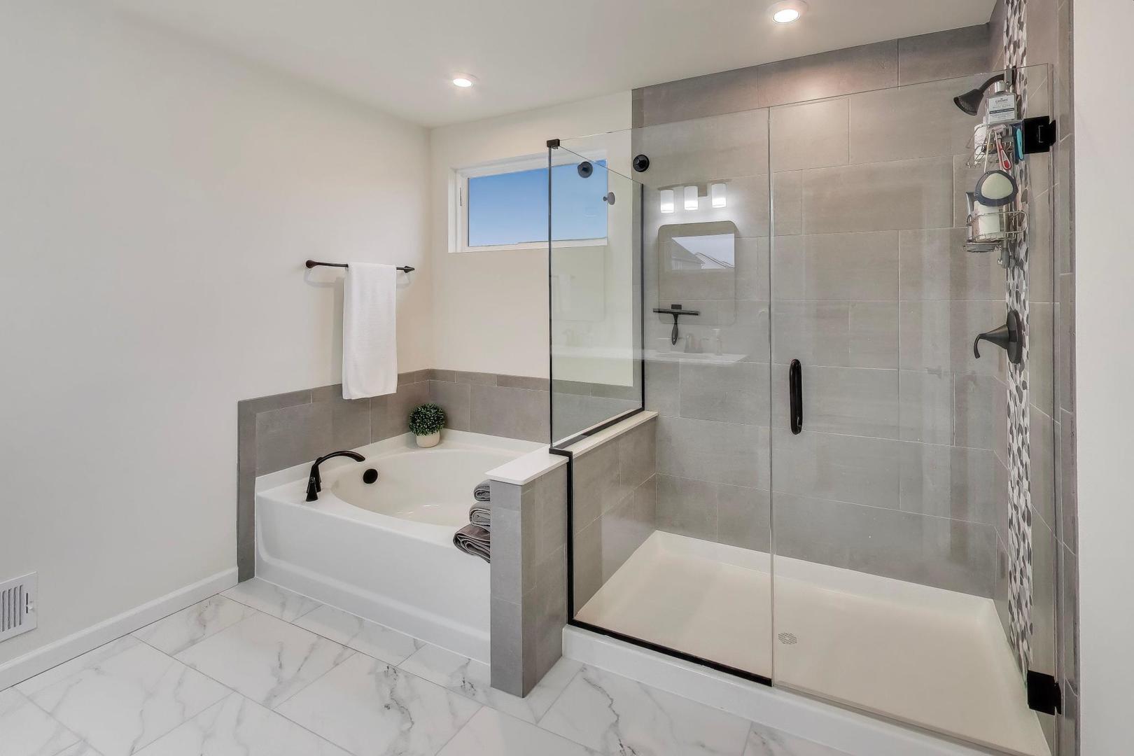 3744 Peregrine Way Elgin, IL 60124 - Photo 15 of 33 a bathroom with a tub and shower