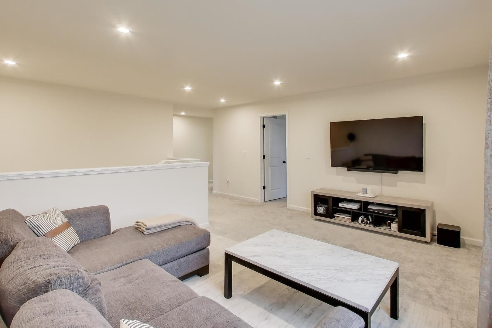 3744 Peregrine Way Elgin, IL 60124 - Photo 18 of 33 a living room with furniture and a flat screen tv