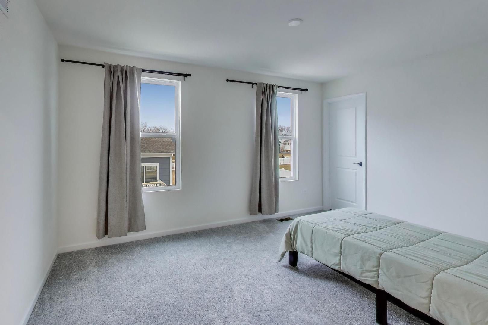 3744 Peregrine Way Elgin, IL 60124 - Photo 24 of 33 a bedroom with a bed and a window