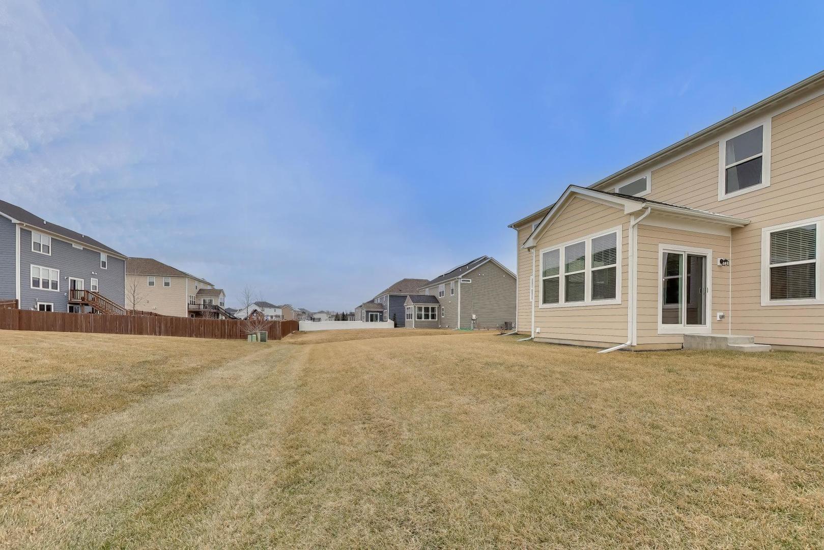 3744 Peregrine Way Elgin, IL 60124 - Photo 27 of 33 a view of an house with backyard and road