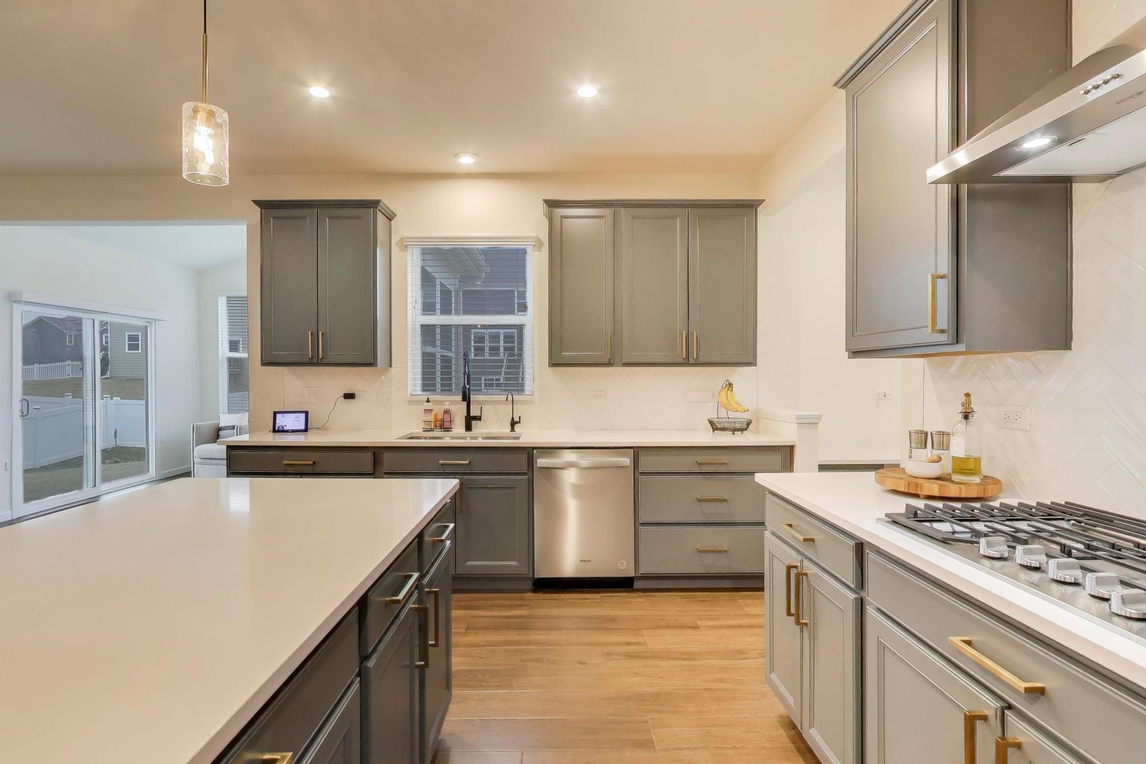 3744 Peregrine Way Elgin, IL 60124 - Photo 5 of 33 a kitchen with a sink stove top oven and cabinets