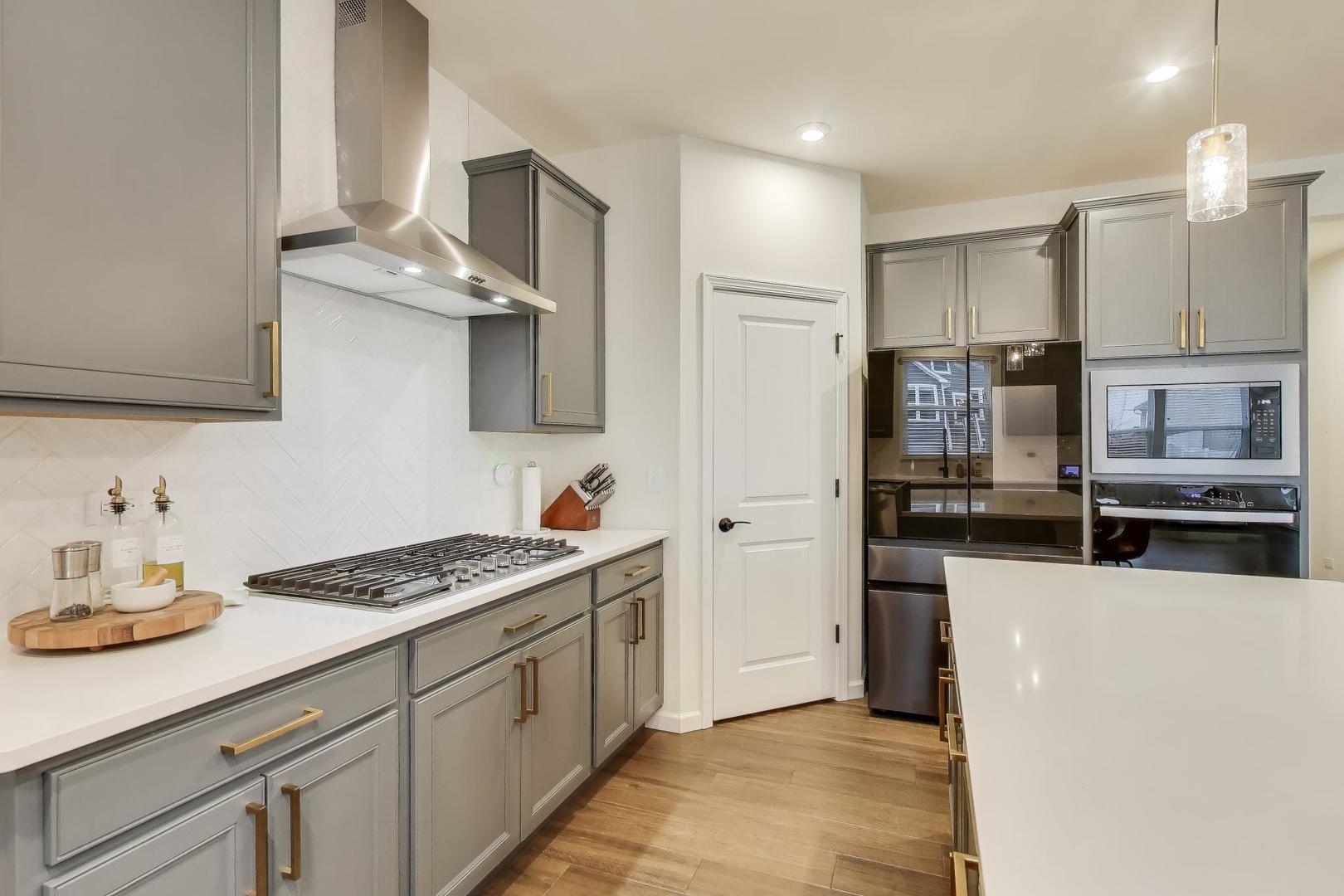 3744 Peregrine Way Elgin, IL 60124 - Photo 6 of 33 a kitchen with stainless steel appliances kitchen island granite countertop a sink and cabinets