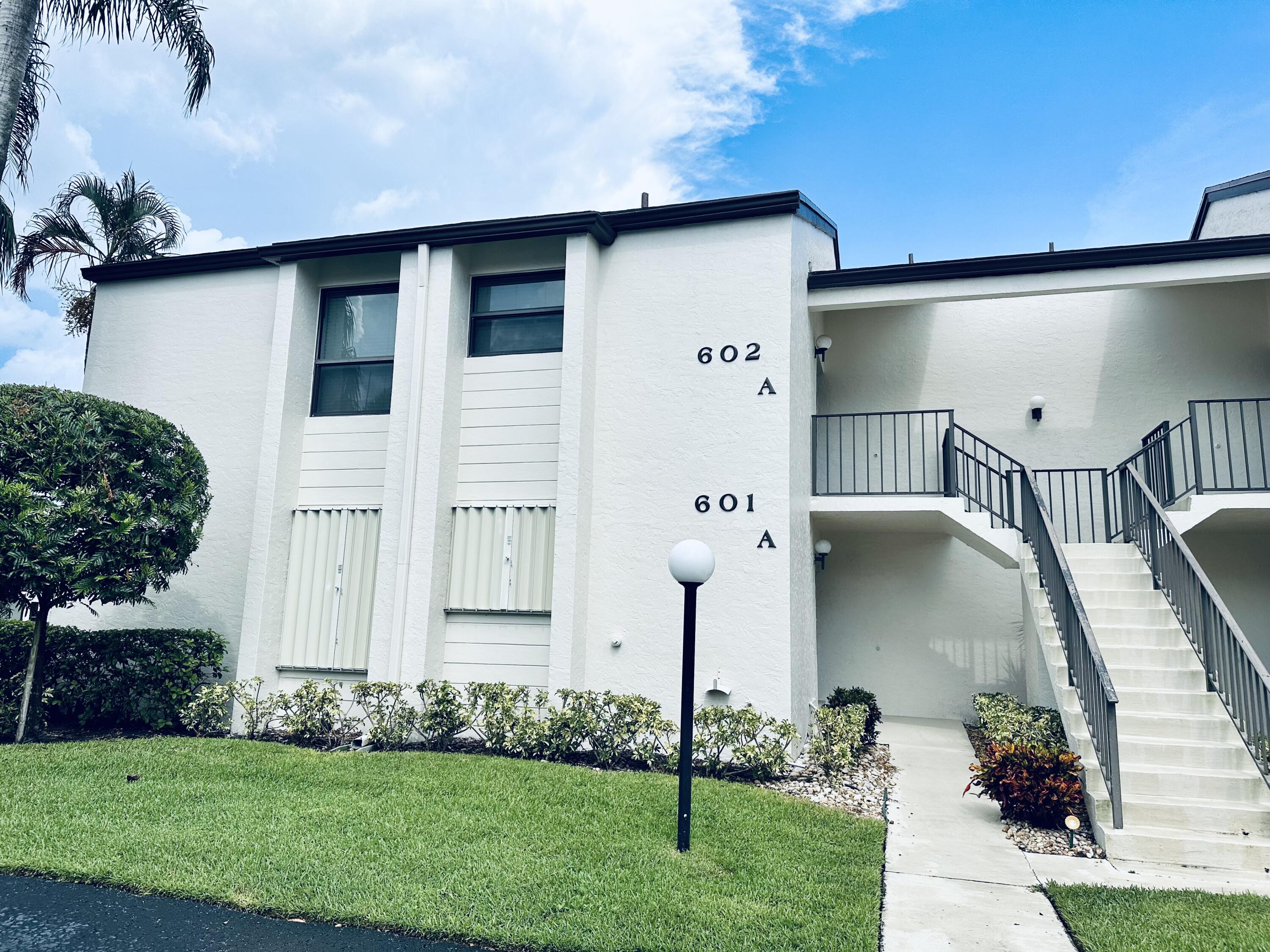 602 Wingfoot Drive, Unit A Jupiter, FL 33458 - Photo 1 of 29 a front view of a house with garden