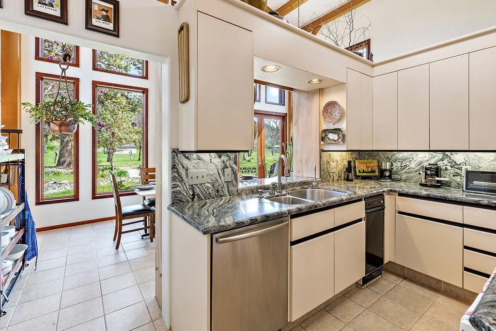 2076 Upper Applegate Road Jacksonville, OR 97530 - Photo 14 of 35 a kitchen with granite countertop a sink and a window