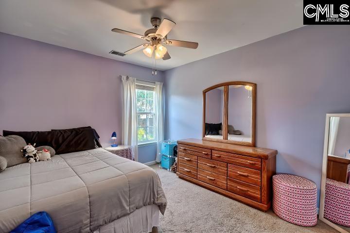 209 Eagle Pointe Drive Chapin, SC 29036 - Photo 26 of 40 a bedroom with a bed and a chandelier