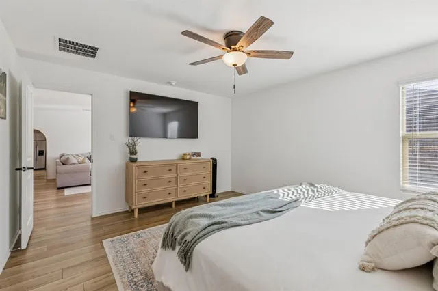 a bedroom with a bed and a flat screen tv