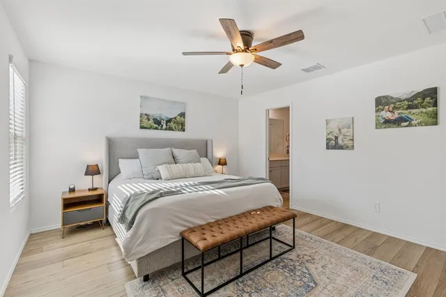 a bedroom with a bed and a painting on the wall