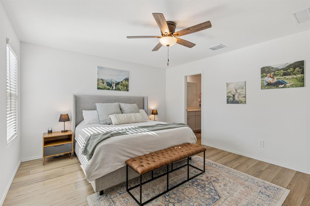 437 Frio Pass Trail Fort Worth, TX 76052 - Photo 15 of 28 a bedroom with a bed and a painting on the wall