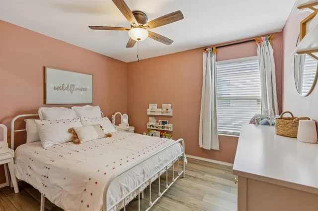 a bedroom with a large bed and a chandelier