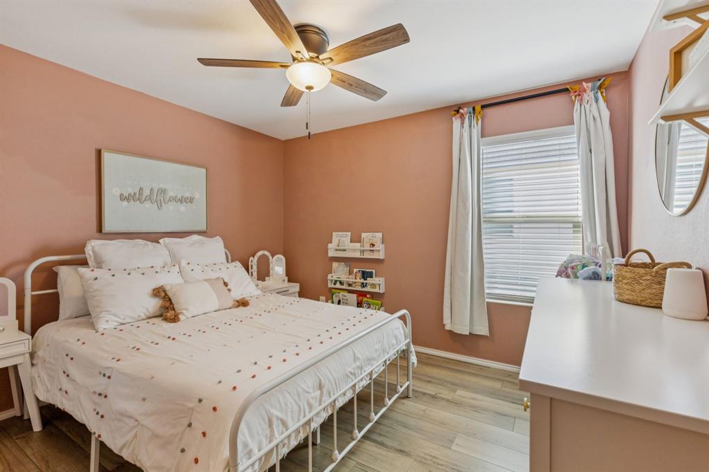 437 Frio Pass Trail Fort Worth, TX 76052 - Photo 17 of 28 a bedroom with a large bed and a chandelier