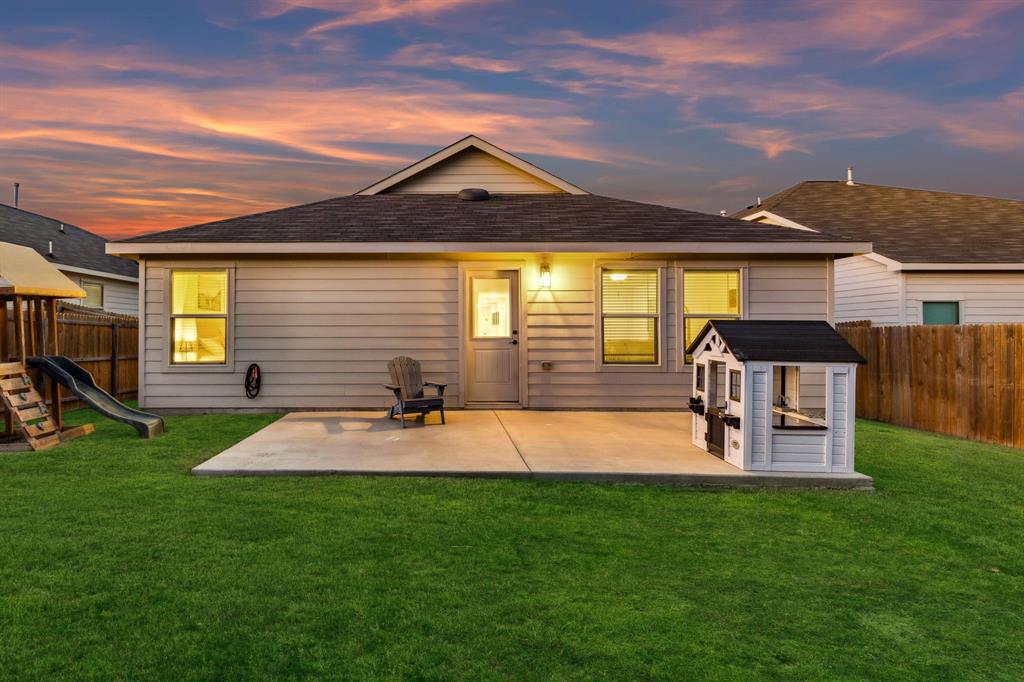 437 Frio Pass Trail Fort Worth, TX 76052 - Photo 23 of 28 a view of a backyard with table and chairs and potted plants