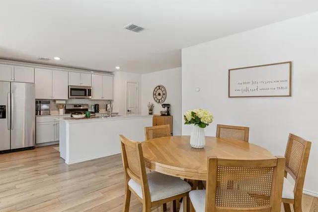 a kitchen with a table and chairs in it