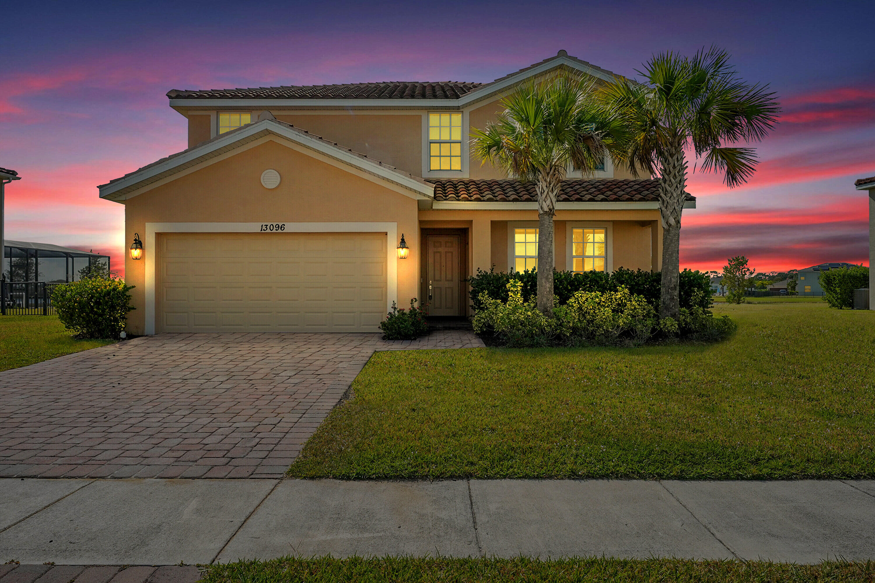 13096 Northwest Copper Creek Drive Port St. Lucie, FL 34987 - Photo 1 of 64 a front view of a house with a garden