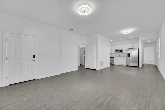 a kitchen with stainless steel appliances a refrigerator sink and stove