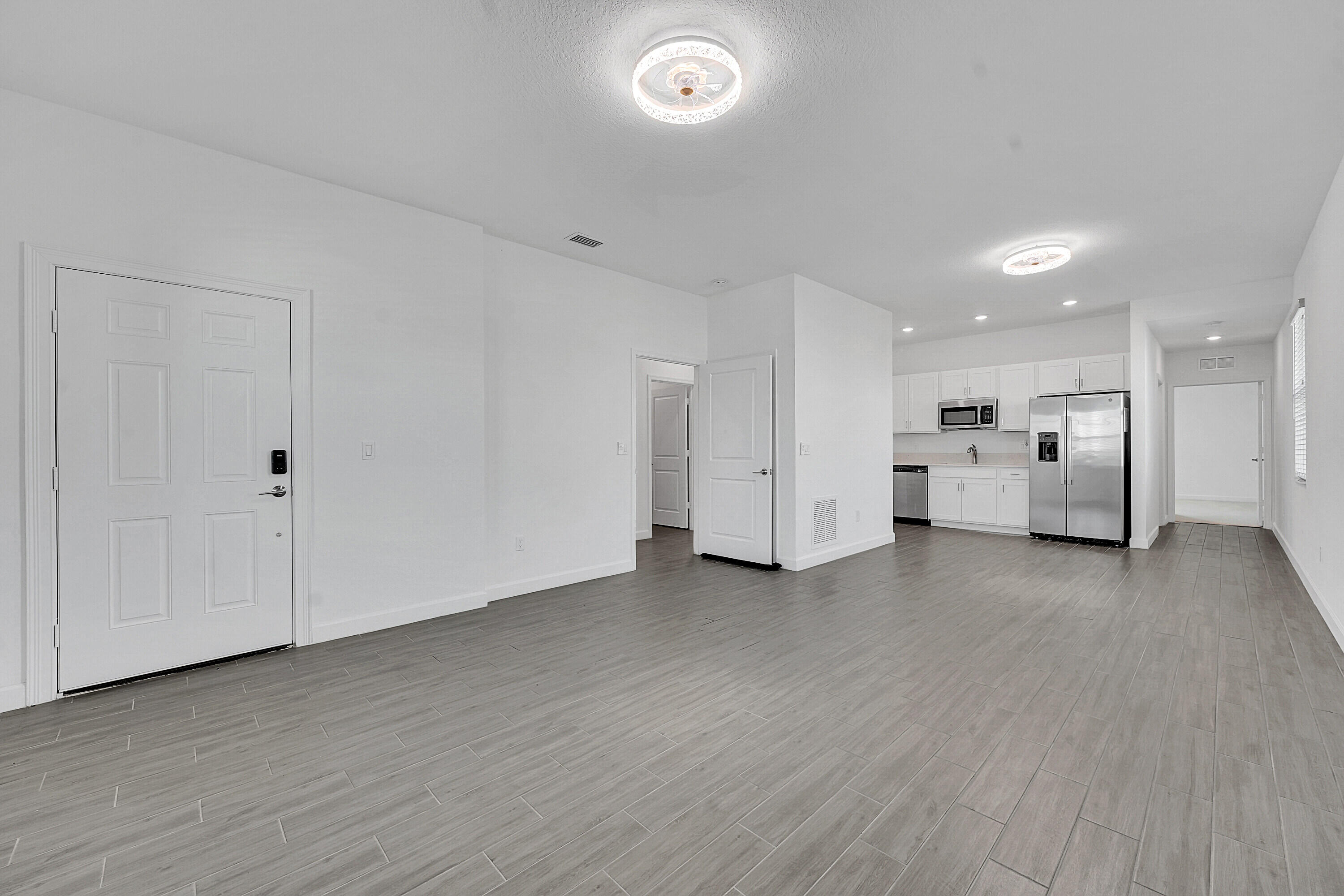 13096 Northwest Copper Creek Drive Port St. Lucie, FL 34987 - Photo 13 of 64 a view of an empty room with closet and cabinet
