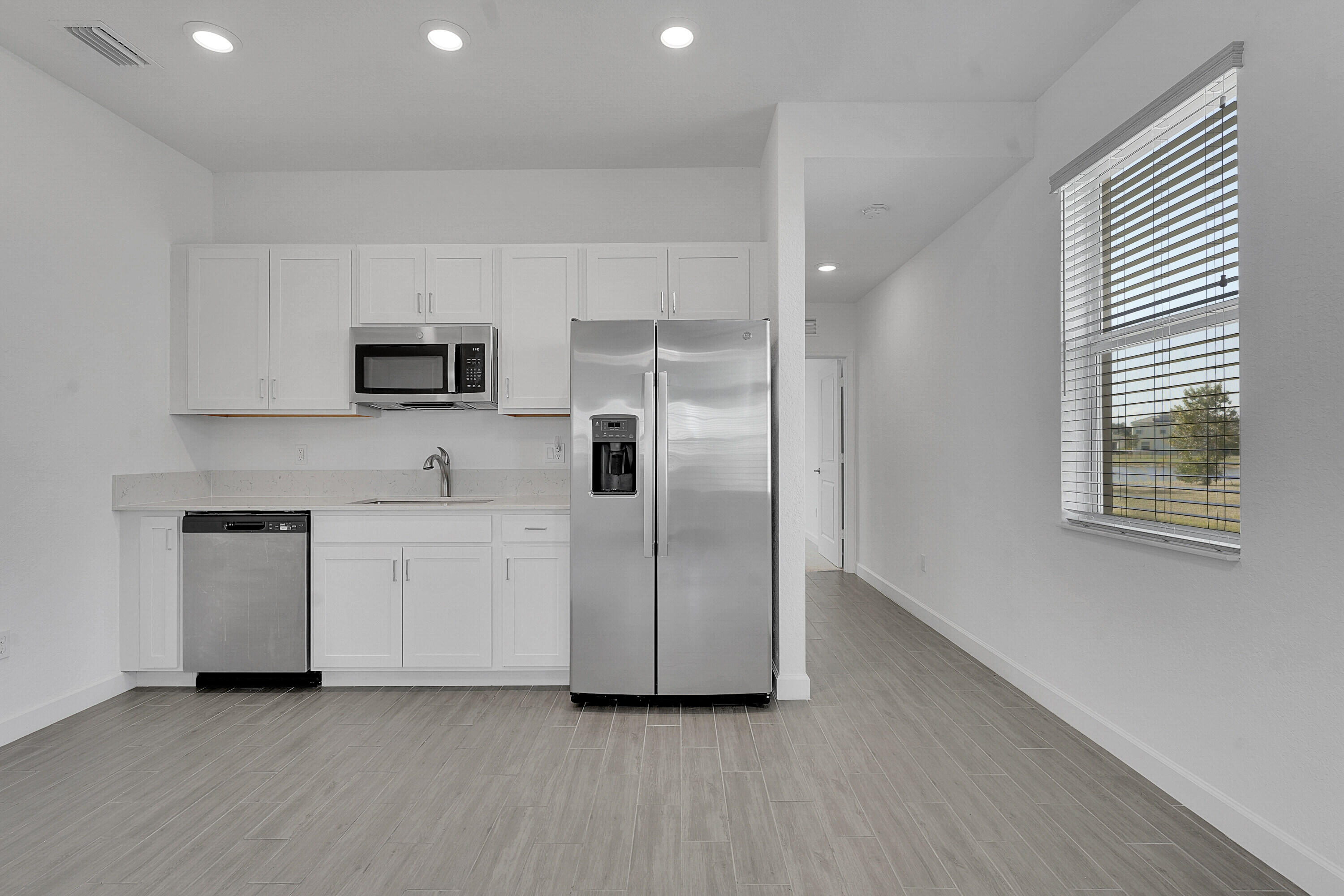 13096 Northwest Copper Creek Drive Port St. Lucie, FL 34987 - Photo 15 of 64 a kitchen with stainless steel appliances a refrigerator sink and stove