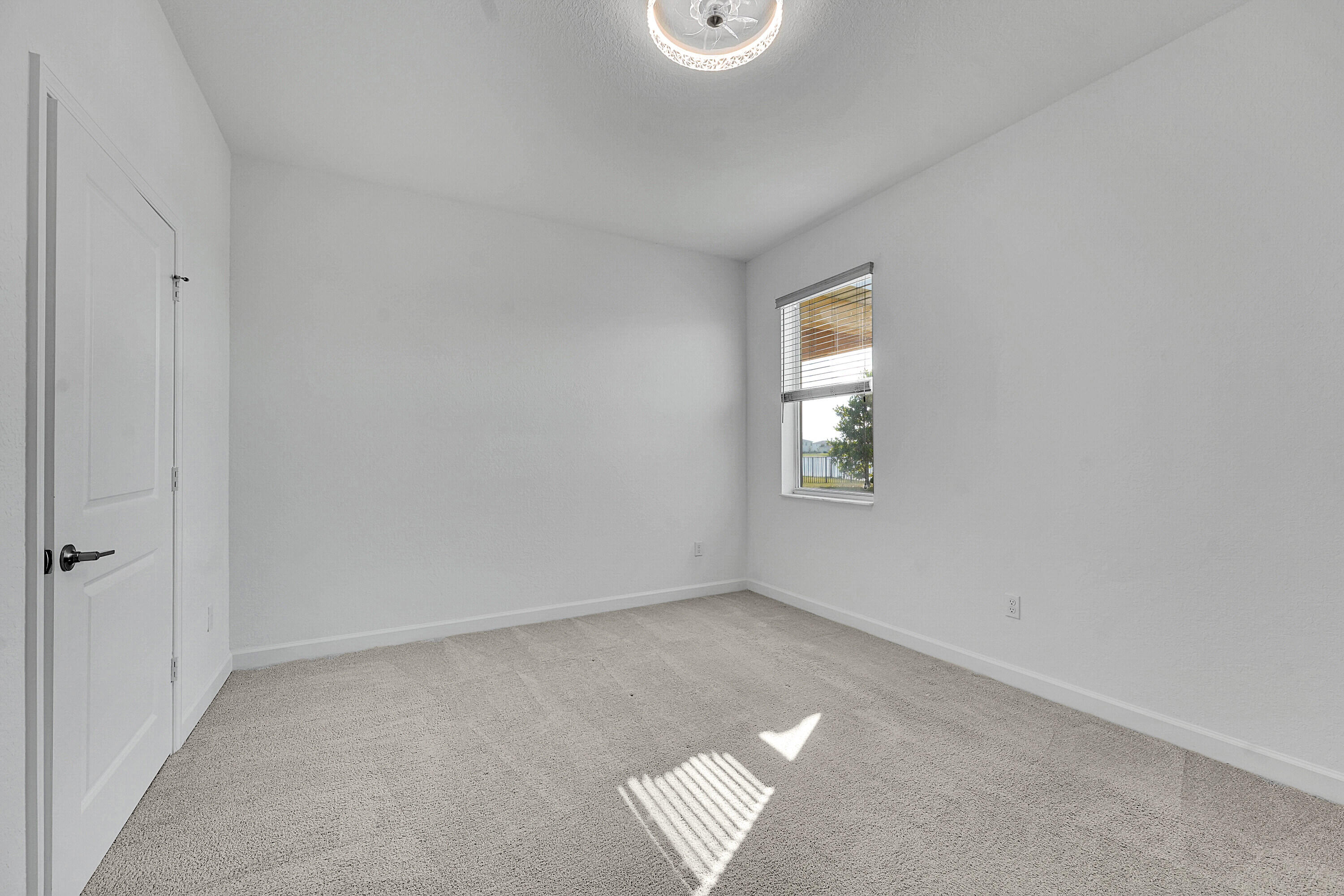 13096 Northwest Copper Creek Drive Port St. Lucie, FL 34987 - Photo 16 of 64 an empty room with windows