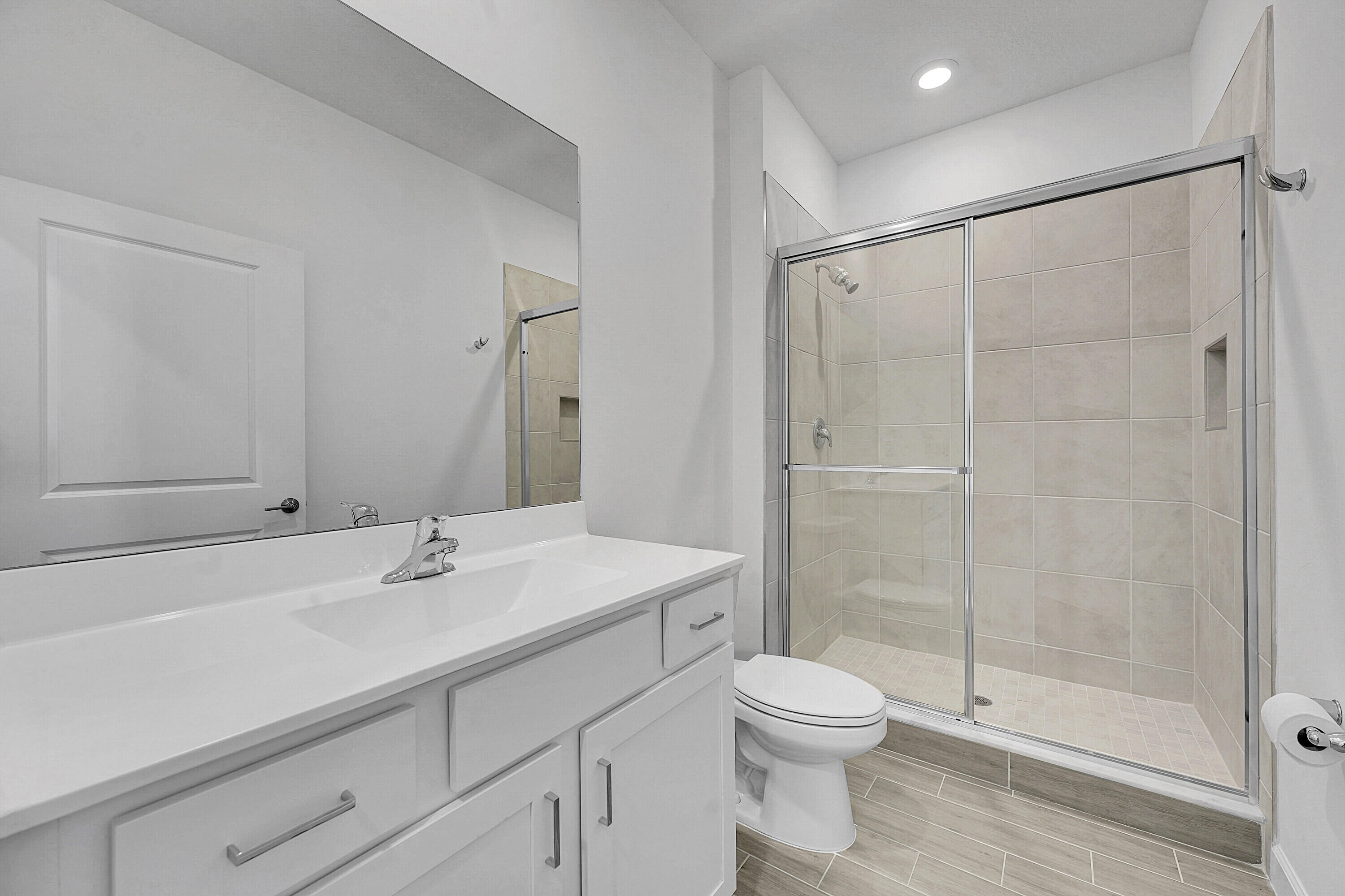 13096 Northwest Copper Creek Drive Port St. Lucie, FL 34987 - Photo 18 of 64 a bathroom with a shower sink vanity mirror and toilet