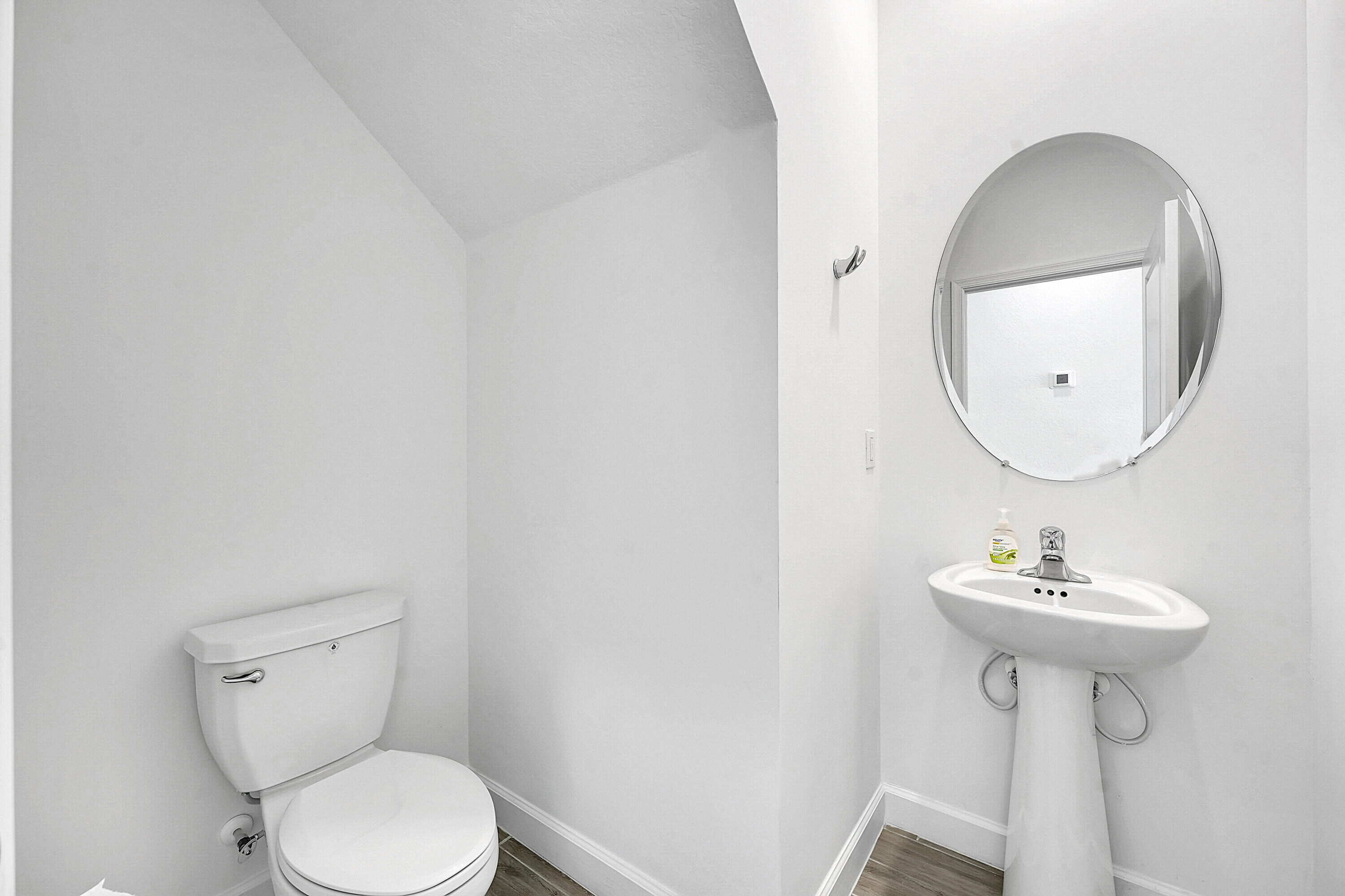 13096 Northwest Copper Creek Drive Port St. Lucie, FL 34987 - Photo 20 of 64 a bathroom with a sink a toilet and a mirror
