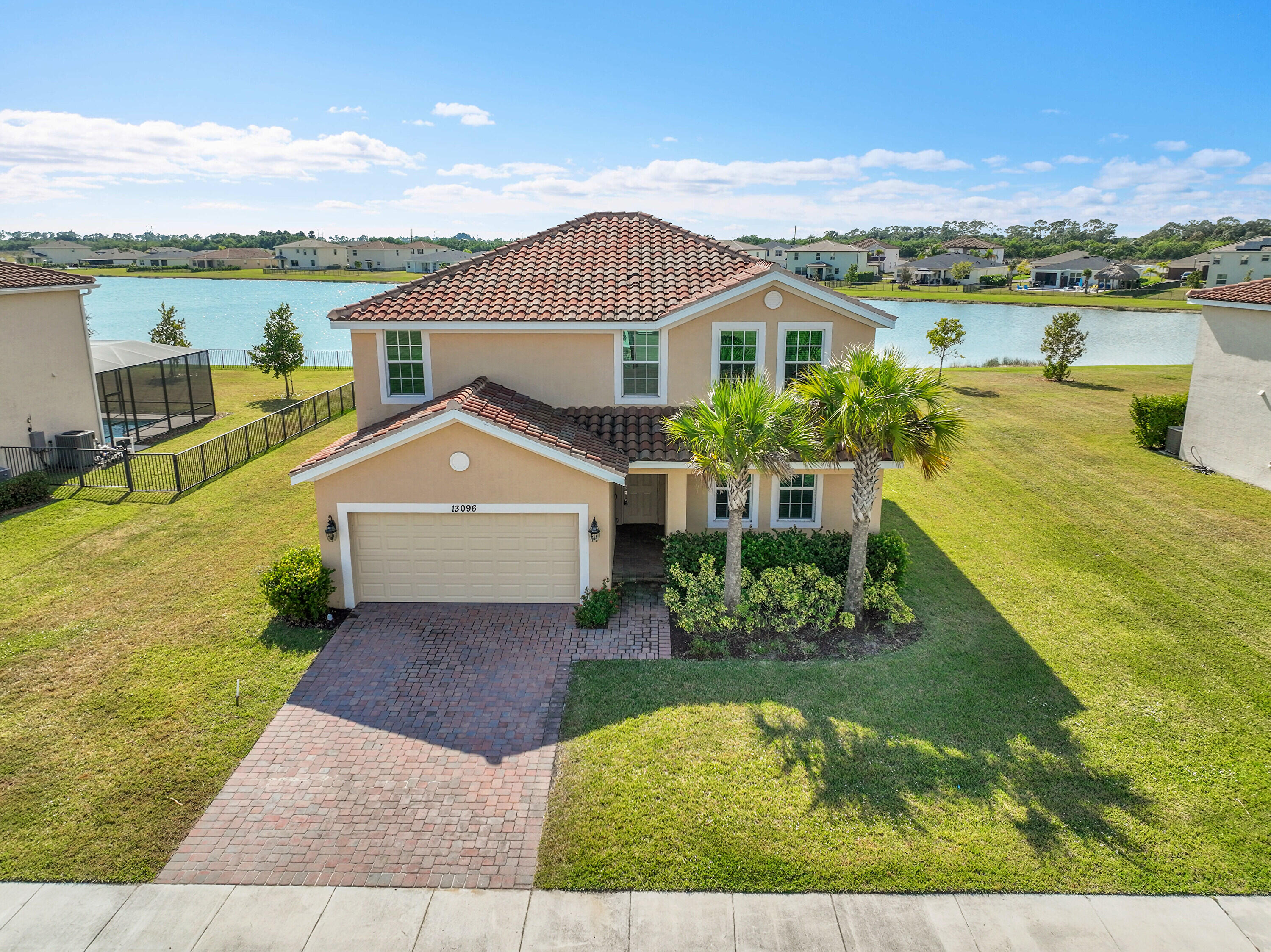 13096 Northwest Copper Creek Drive Port St. Lucie, FL 34987 - Photo 40 of 64 a front view of a house with a yard