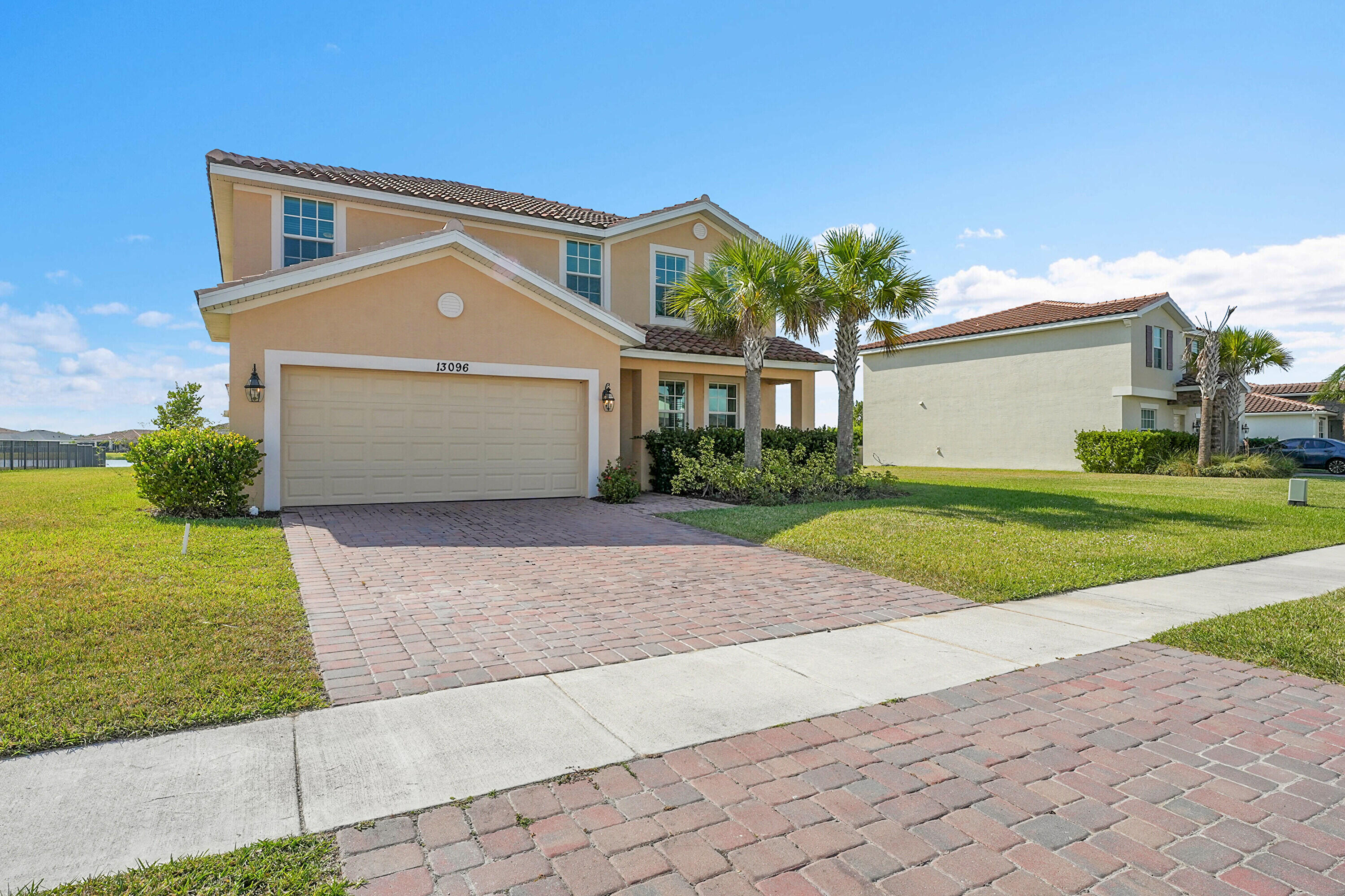 13096 Northwest Copper Creek Drive Port St. Lucie, FL 34987 - Photo 4 of 64 a front view of a house with a yard and garage