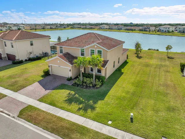 an aerial view of a house with pool and a lake view