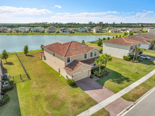 an aerial view of a house with a swimming pool yard and outdoor seating