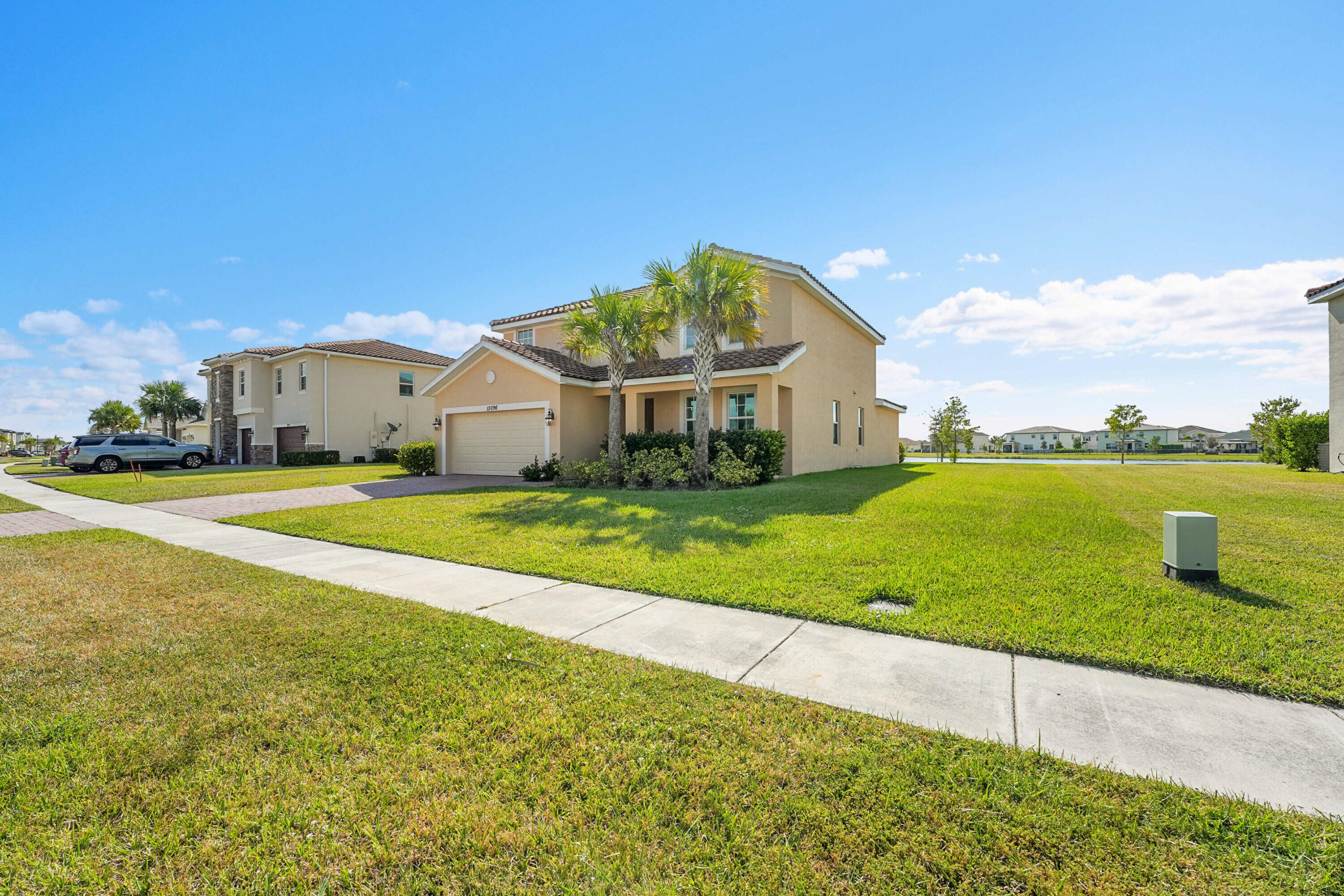 13096 Northwest Copper Creek Drive Port St. Lucie, FL 34987 - Photo 5 of 64 a view of a house with a big yard and large trees