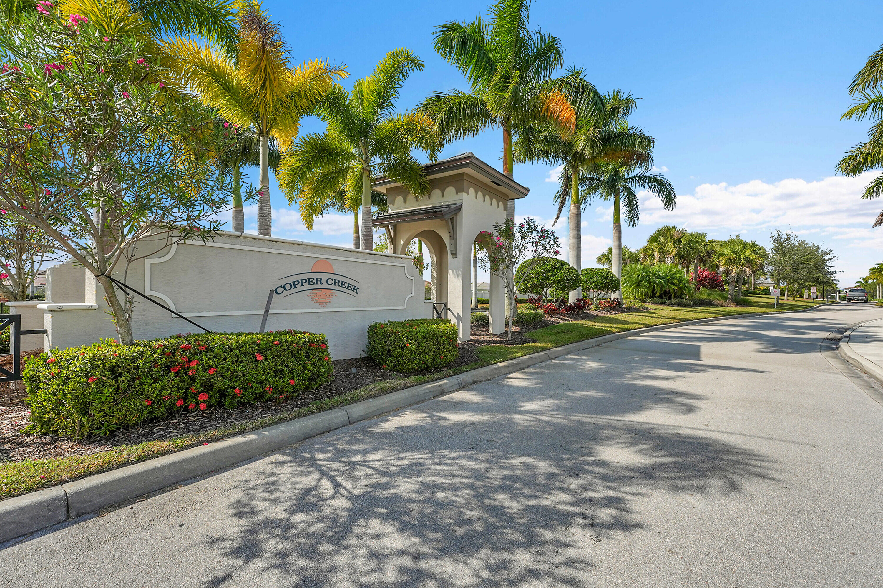 13096 Northwest Copper Creek Drive Port St. Lucie, FL 34987 - Photo 58 of 64 a front view of a house with a yard and a garage
