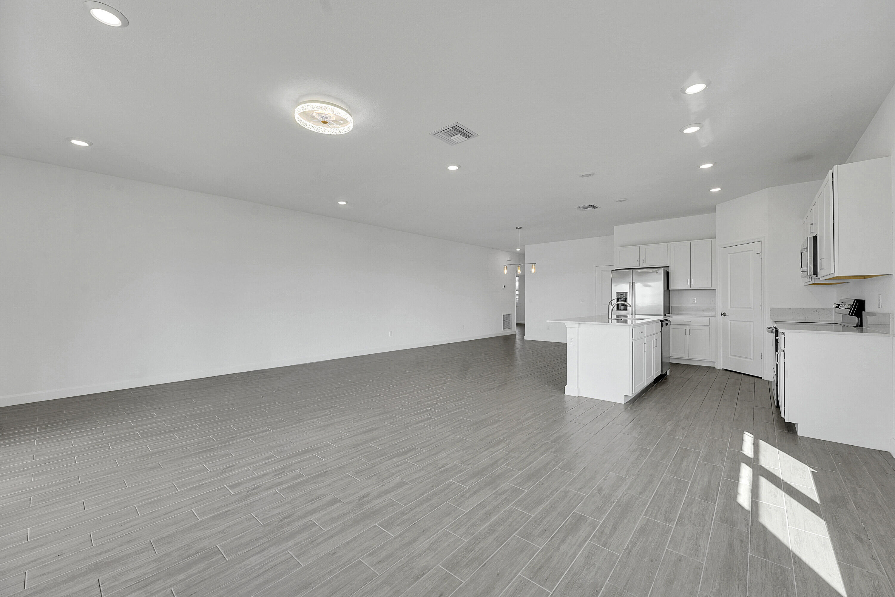 13096 Northwest Copper Creek Drive Port St. Lucie, FL 34987 - Photo 8 of 64 a view of a kitchen with wooden floor and a sink