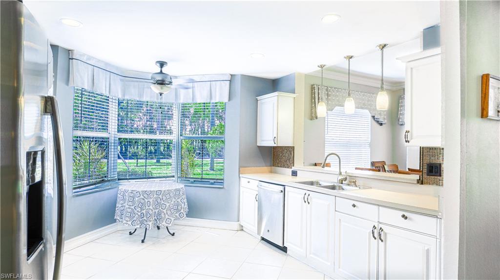 300 Diamond Circle, Unit 301 Naples, FL 34110 - Photo 15 of 43 a spacious bathroom with a granite countertop sink a toilet and a mirror