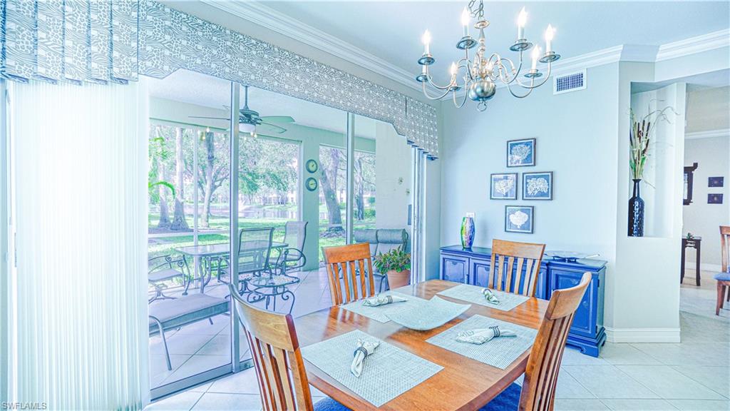 300 Diamond Circle, Unit 301 Naples, FL 34110 - Photo 20 of 43 a dining room with furniture a rug and a chandelier