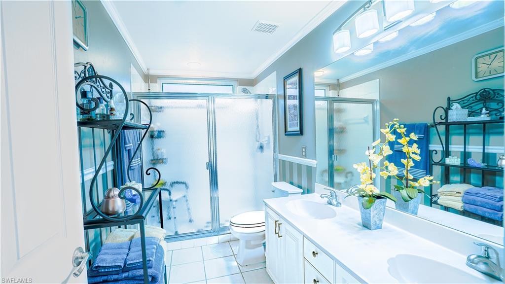 300 Diamond Circle, Unit 301 Naples, FL 34110 - Photo 22 of 43 a bathroom with a sink a toilet and shower