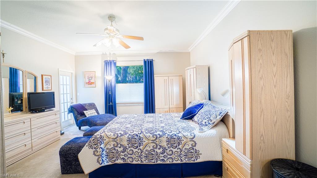 300 Diamond Circle, Unit 301 Naples, FL 34110 - Photo 23 of 43 a bedroom with a bed television and a window