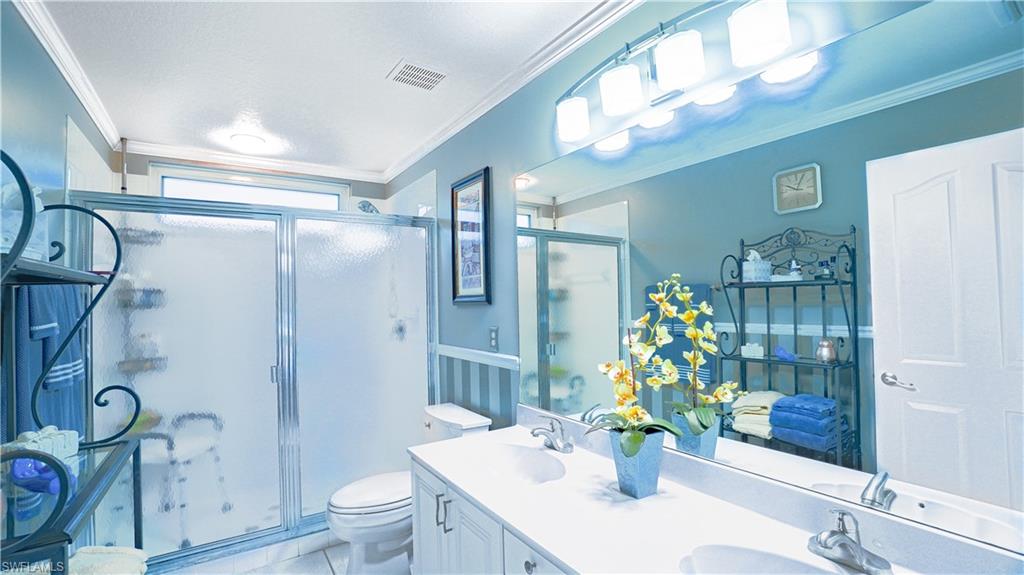 300 Diamond Circle, Unit 301 Naples, FL 34110 - Photo 24 of 43 a bathroom with a sink a toilet and shower