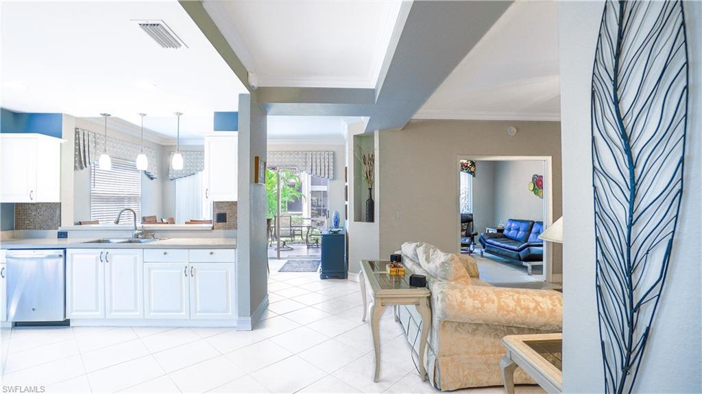 300 Diamond Circle, Unit 301 Naples, FL 34110 - Photo 30 of 43 a kitchen with granite countertop a sink and dishwasher a oven with cabinets