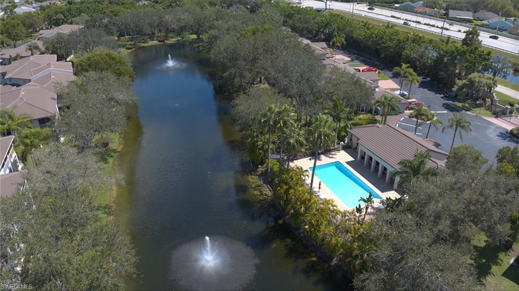 300 Diamond Circle, Unit 301 Naples, FL 34110 - Photo 34 of 43 an aerial view of a house with a yard and lake view