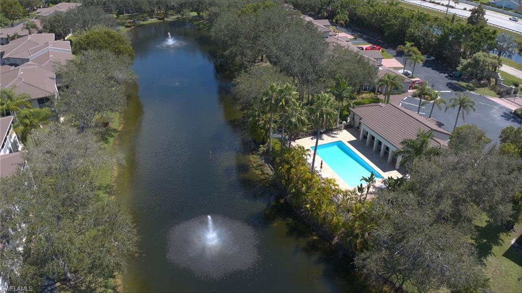 300 Diamond Circle, Unit 301 Naples, FL 34110 - Photo 37 of 43 an aerial view of a house with a yard and lake view