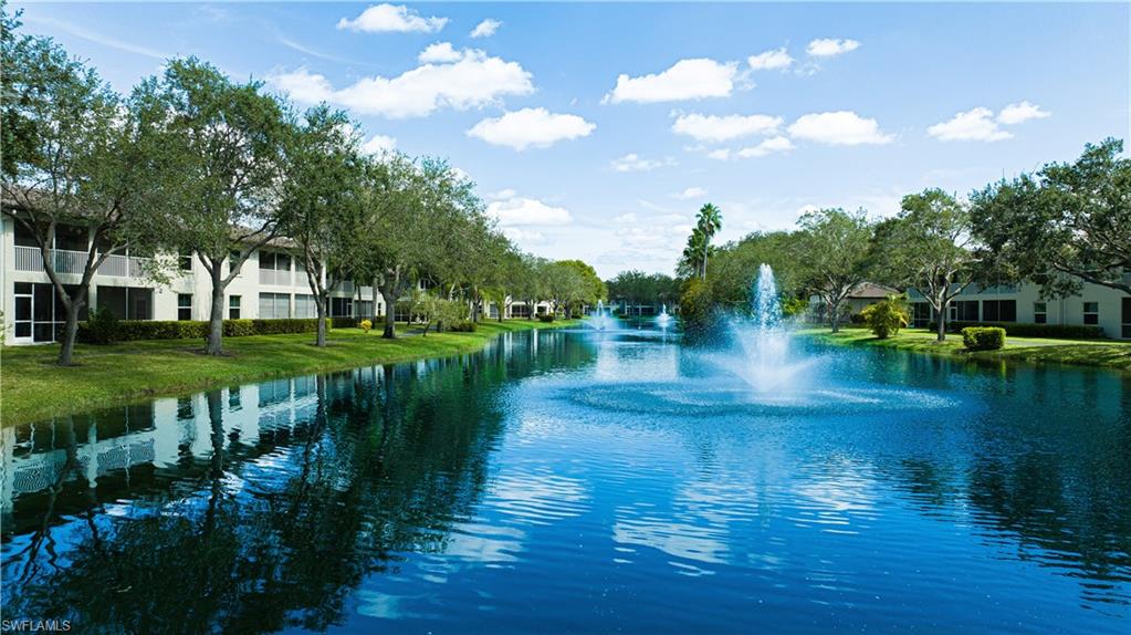 300 Diamond Circle, Unit 301 Naples, FL 34110 - Photo 4 of 43 a view of a lake with houses