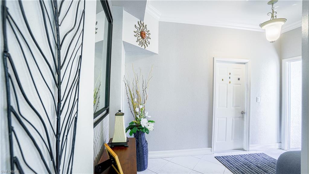 300 Diamond Circle, Unit 301 Naples, FL 34110 - Photo 41 of 43 a view of a potted plant in a corridor